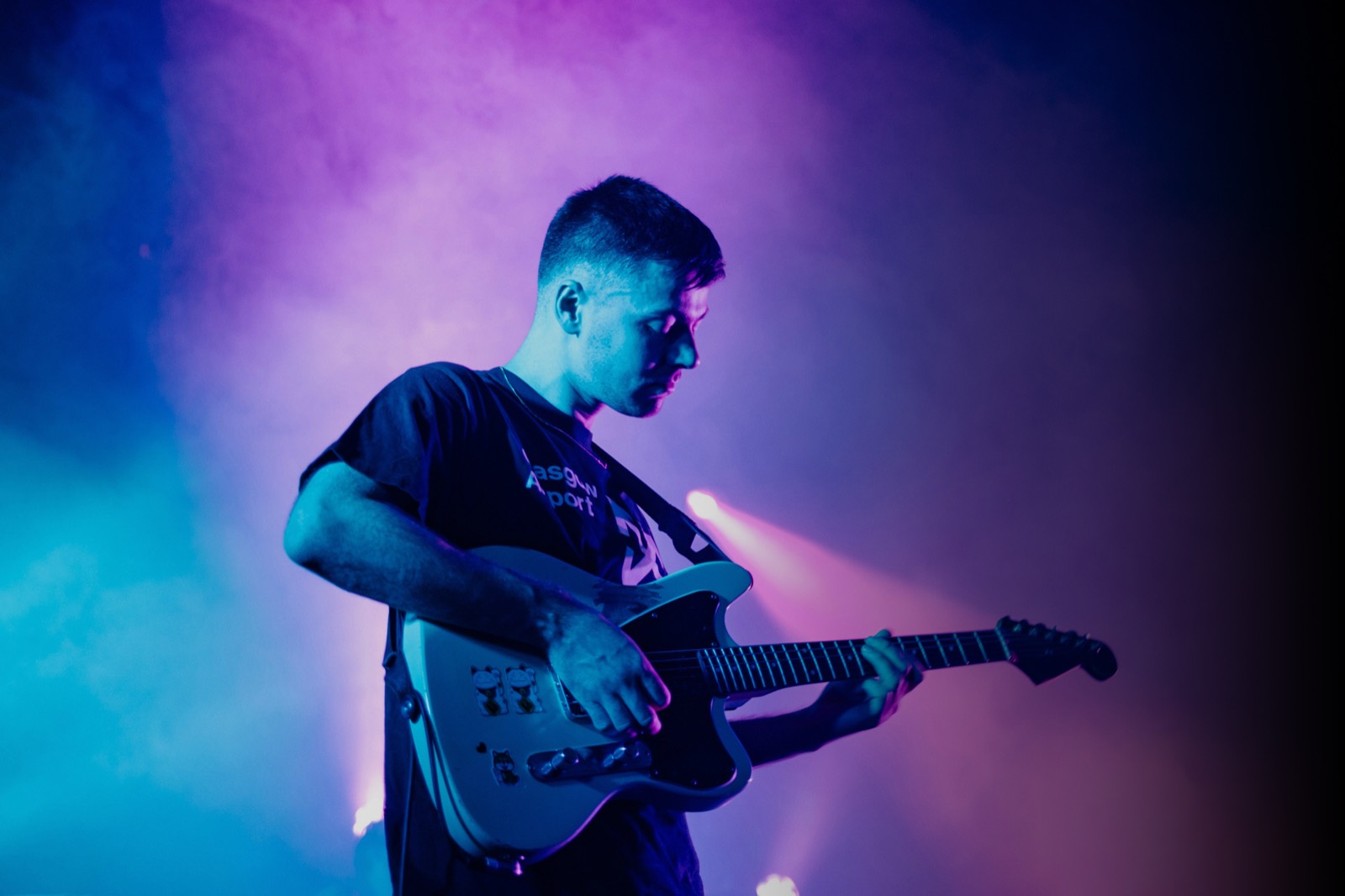 Artist performing under colored stage lights